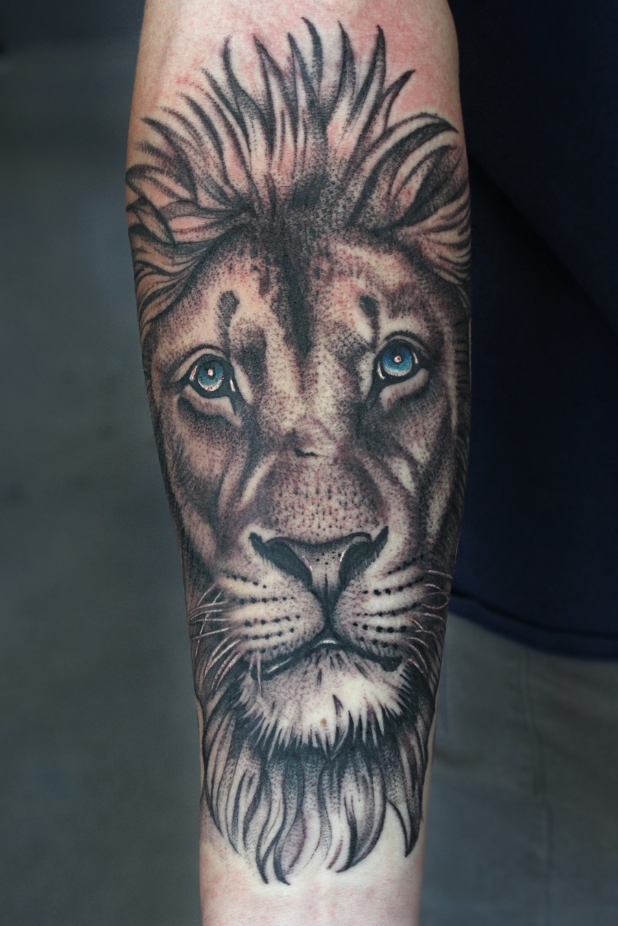 lion with colored eyes tattoo